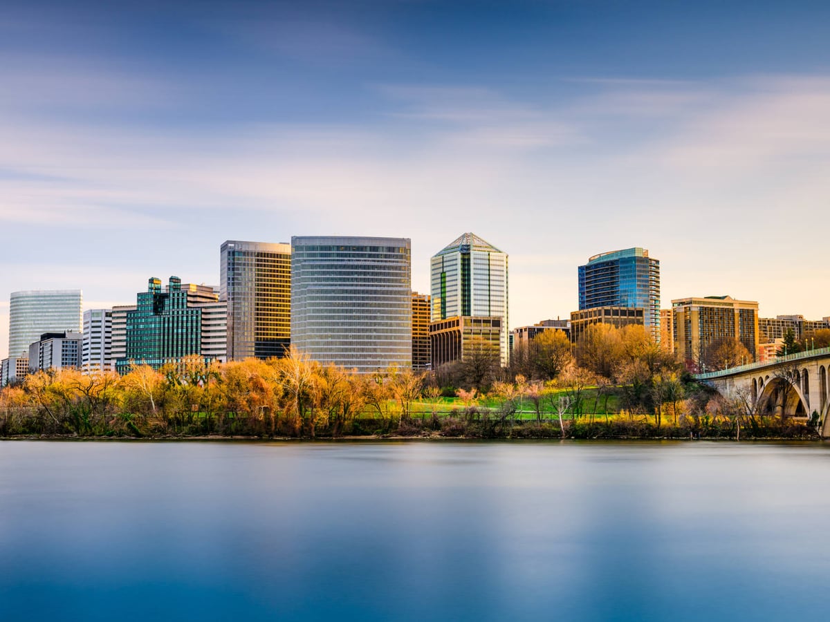 Arlington skyline, riverside trees and an arched bridge beside the Potomac River